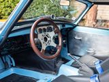 a steering wheel and dashboard of a car in a parking lot