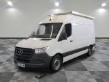 Le fourgon Mercedes-Benz Sprinter est garé dans une pièce au sol carrelé en damier.