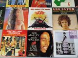 many different album covers on the table together