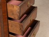 a wooden chest of drawers with three drawers on top of it