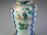 a vase that is sitting on a stand on a table