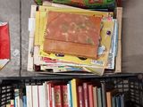 a basket full of books on the floor next to a chair