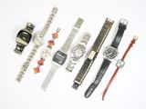 a lot of watches that are sitting on a white surface