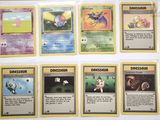 a lot of pokemon cards that are on the table