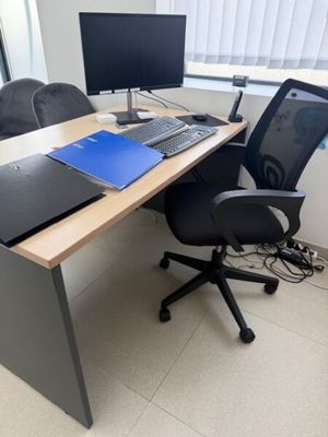 a desk with a laptop and a monitor on it
