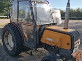 a tractor that is parked in the dirt