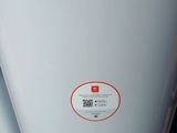 a white refrigerator with a red sticker on it