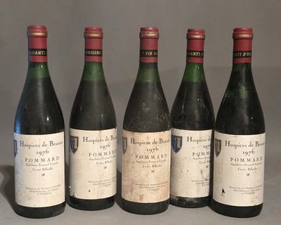 six bottles of wine are lined up on a table