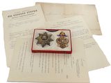 a small box with two medals on top of a piece of paper