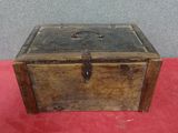 an old wooden box sitting on top of a red carpet