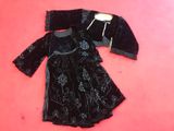 black velvet dress and jacket on a pink background