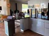 a kitchen that has a laptop on the counter in it