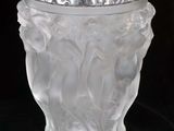 a glass vase that is sitting on a black surface