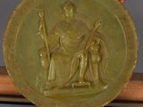 bronze medal depicting a man and a woman on a bench