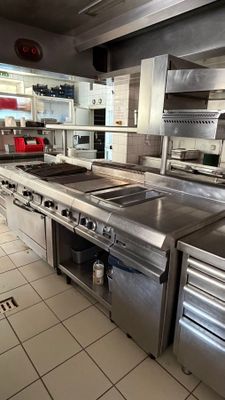 a large kitchen with stainless steel appliances in it