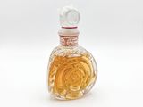 a small glass bottle with a rose inside of it