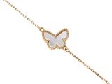 a white butterfly bracelet on a gold chain