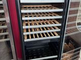 an image of a refrigerator with many racks of food inside of it