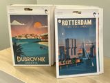 two boxes of posters on a table in a room
