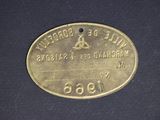 an old brass plate with the name of a man who is riding a horse
