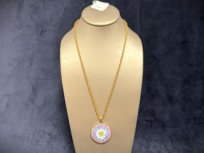 a white mannequin with a pink and yellow necklace on it