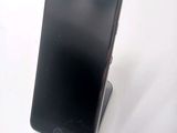 a cell phone that is sitting on top of a stand