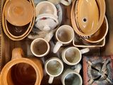 many cups and saucers in a box on the floor
