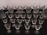 a lot of wine glasses and a decanter on a table