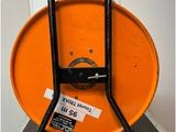 an image of a large orange drum with a black handle