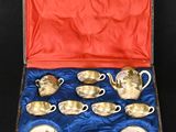 six cups and a saucer in a box