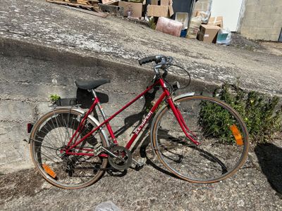 a red bicycle parked on the side of the road