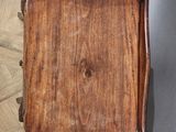 an old wooden tray sitting on top of a table on top of a wooden floor