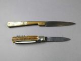 two knives that are sitting next to each other on a table