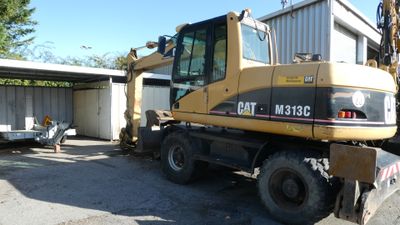 a picture of a construction vehicle parked in front of a building