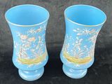 two vases that are sitting on a black surface