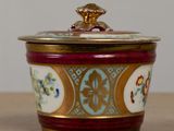 a close up of a decorative container on a table