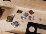 many pieces of metal that are on a wooden table