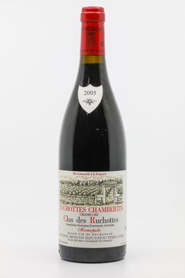 une bouteille de vin rouge posée sur une table blanche