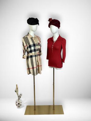 two mannequins dressed in red and black standing next to each other