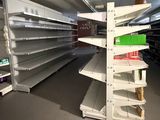many empty shelves in a store that are full of items
