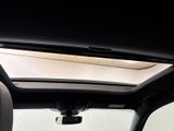 the interior of a car with a sunroof and a dash light