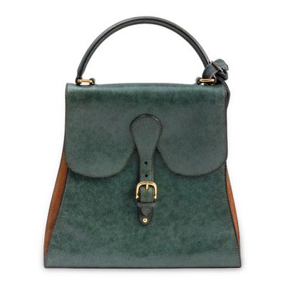 a green and brown handbag on a white background