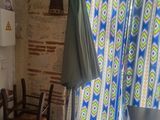 a kitchen with a table, chairs, and an umbrella hanging from the ceiling