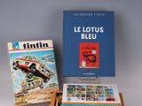 a collection of books on a white surface with a blue box