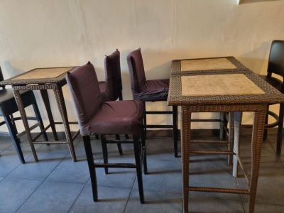 several chairs and a table in a room with a tile floor