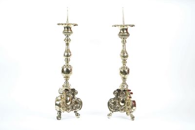 pair of antique silver candlesticks on stand on white background