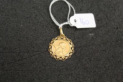 a close up of a gold coin with a tag attached to it