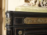 a black and gold chest of drawers with a statue on top of it