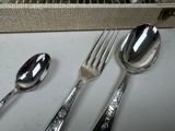 two spoons and a fork sitting on a table