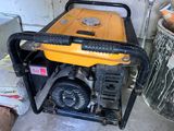 a yellow and black generator sitting on the floor